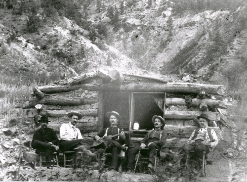 men in front of hut 1860s