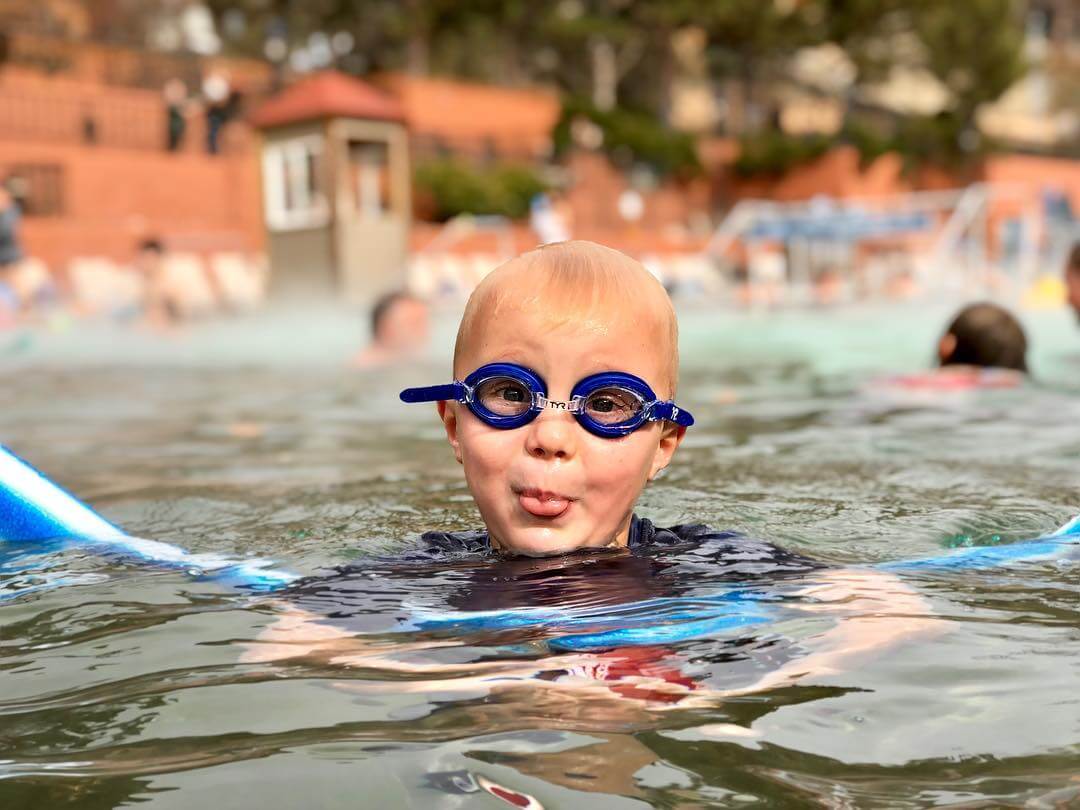Kid wearing goggles in Glenwood Hot Springs pool