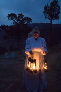 women with lanterns at dark