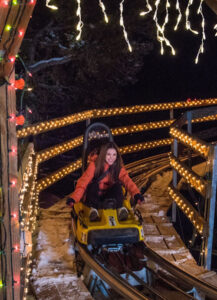 Woman riding Alpine Coaster at Glenwood Caverns Adventure Park in winter