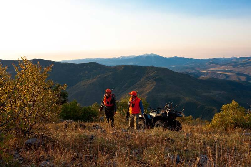 two men and an atv in the colorado backcountry