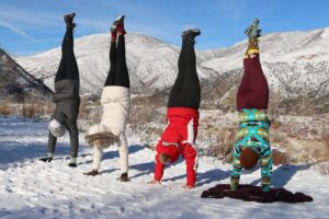 winter hikers doing handstands
