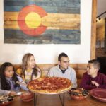 Family eating pizza at Rocky Mountain Pizza