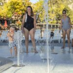 Moms and kids playing in fountains at the Sopris Splash Zone