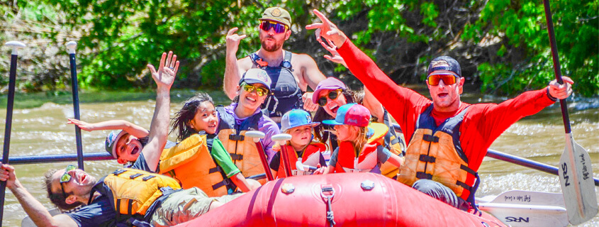 Families having fun while rafting 