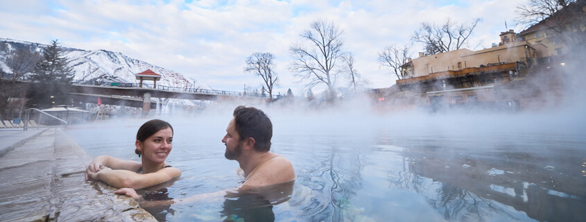 Couple soaking in the hot springs in the winter